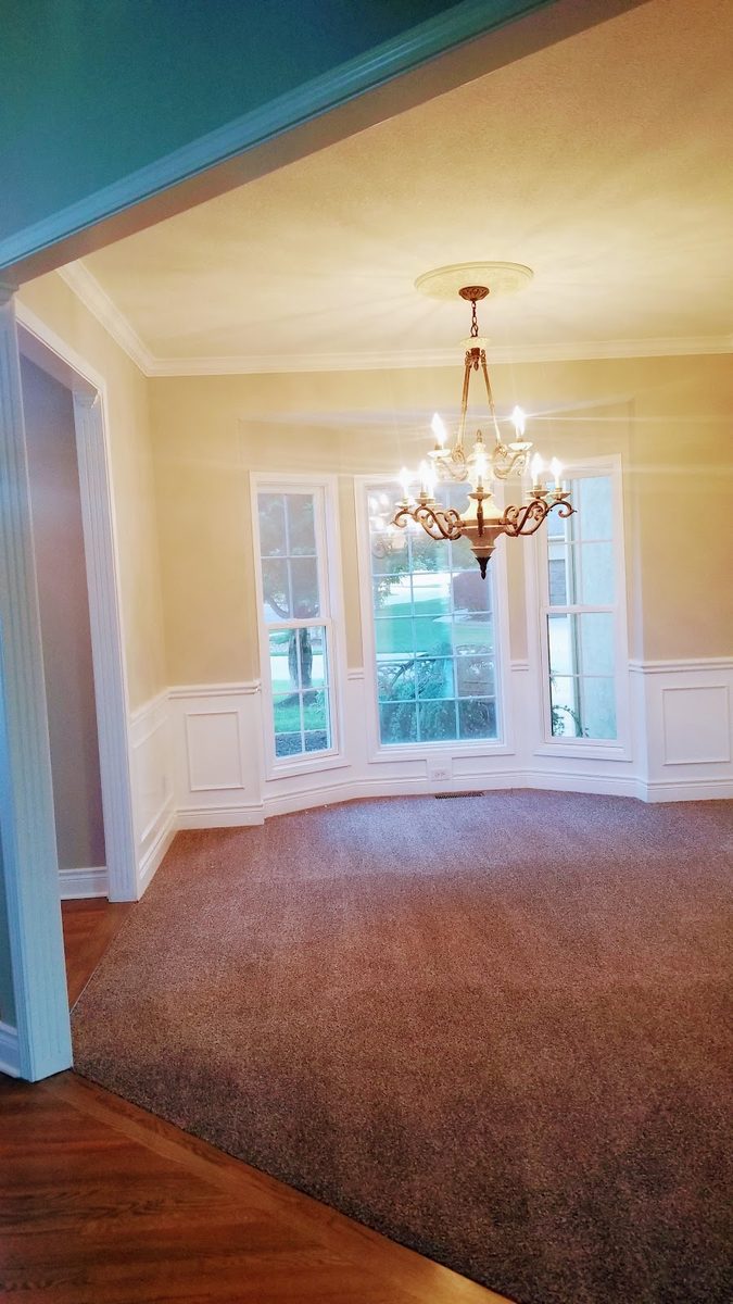 Clean dining room with chandelier